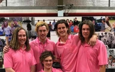 Group of men in pink tops