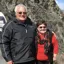 Phil and his wife Vicki standing together with a mountainside in the background
