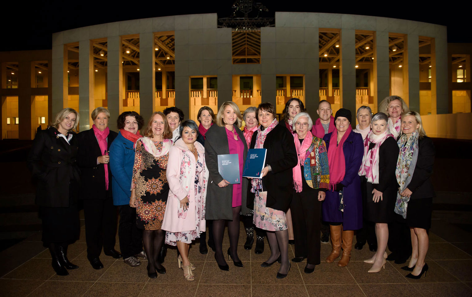 Group of adults, mostly women, standing in a group to present BCNA's 'State of the Nation' report in 2018