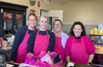 Group of women with pink aprons