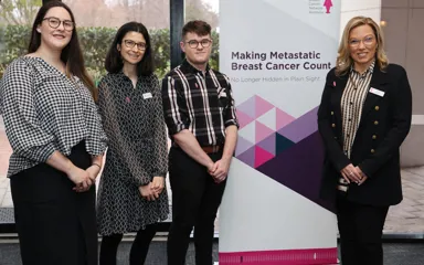 Vicki Durston and BCNA staff in front of Making Metastatic Breast Cancer Count banner