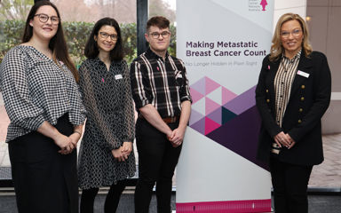 Vicki Durston and BCNA staff in front of Making Metastatic Breast Cancer Count banner
