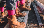 A line of boots with pink socks
