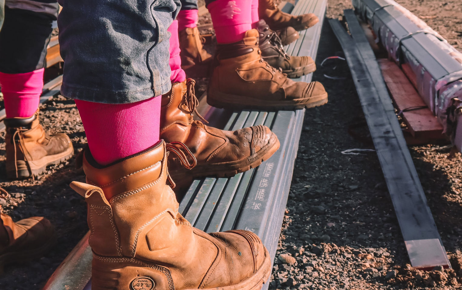 A line of boots with pink socks