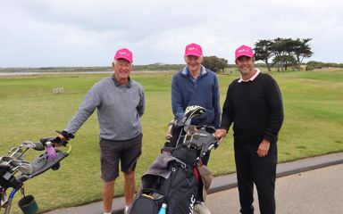 3 men standing at a golf field