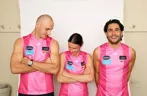 Three football players in pink