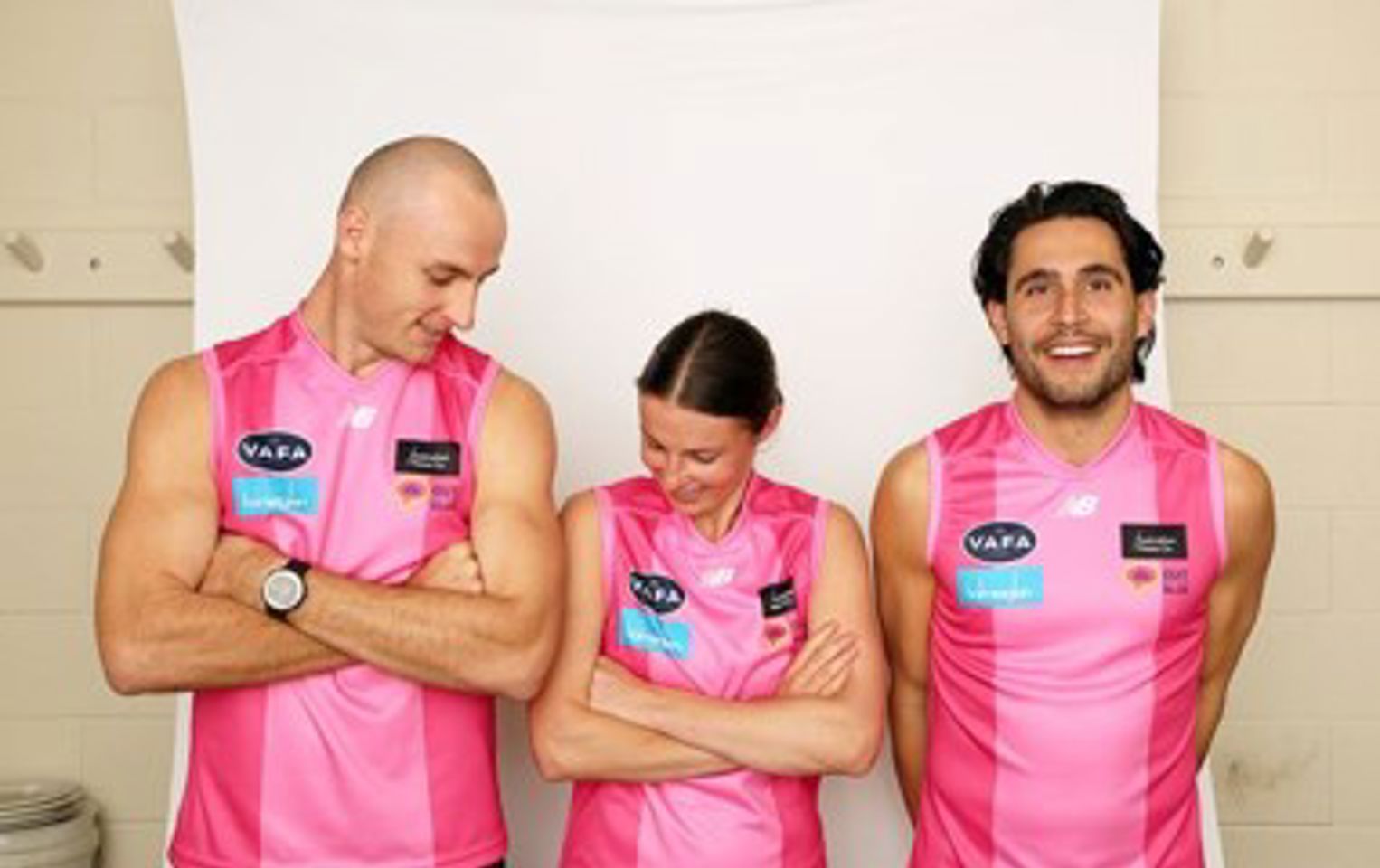 Three football players in pink