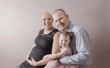 Pregnant mother with breast cancer in family photo